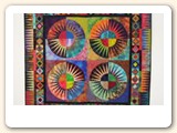 Here is a picture of my quilt "Fireworks" on the Hang it Dang it. The wall hanging is 51" x 51".  I love the way it hangs and the Hang it Dang it was so easy to use. I will be ordering more of them.  Your company was very prompt in sending it and it was in excellent condition.
- Pat, Tennessee